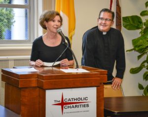 Eileen Larum, Board Member of the Chi-Town Jazz Festival presents a check to Catholic Charities, received by Msgr. Boland and Father Wayne at St. Vincent Center in Chicago.