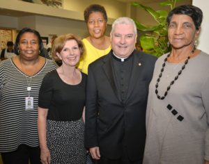 Eileen Larum, Board Member of the Chi-Town Jazz Festival presents a check to Catholic Charities, received by Msgr. Boland and Father Wayne at St. Vincent Center in Chicago.